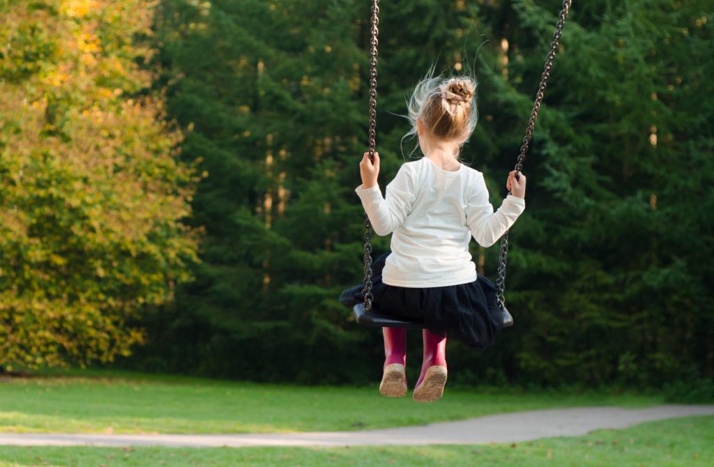 A child swings on a playground. Clemmons Family Law attorneys can help with child support needs. Photo by Skitterphoto from Pexels